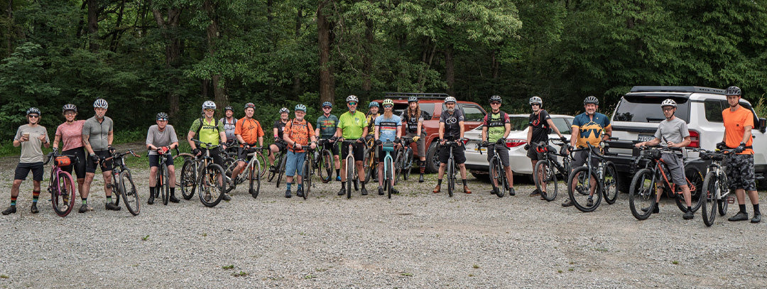 Flat Tire Greensburg, PA Group of people with mountain bikes posing for a photo outdoors.